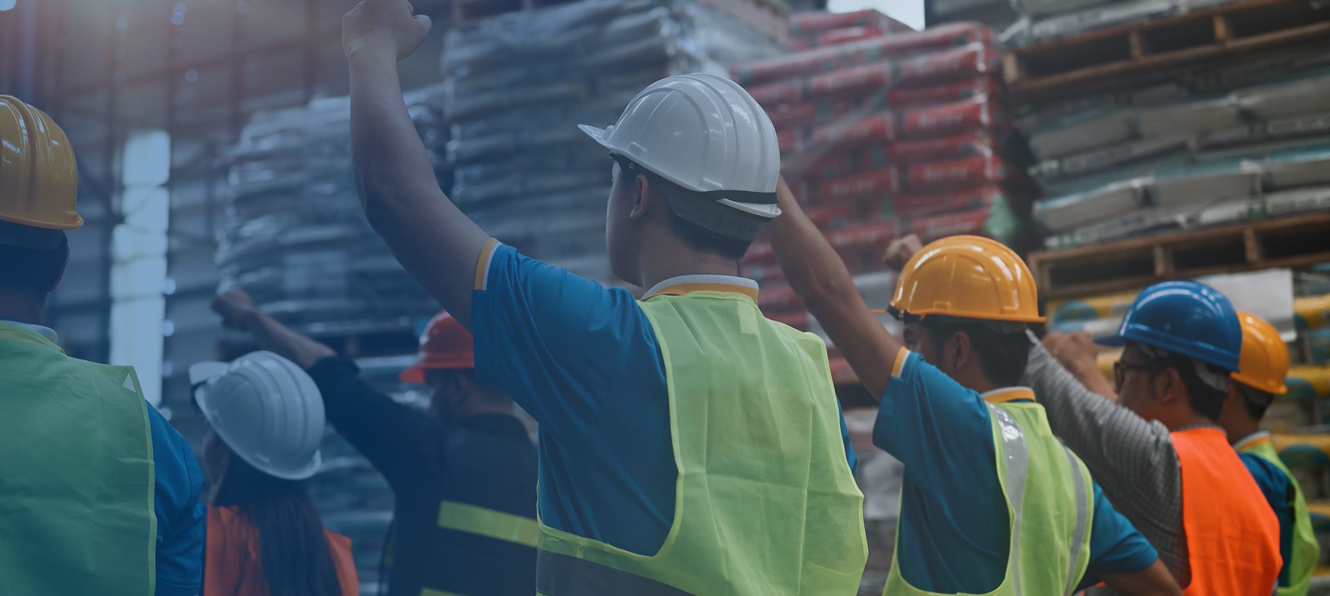 Construction workers wearing hard hats and vests.