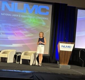 Speaker on stage at NLMC conference